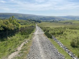 The image shows the section of Pennine Bridleway a year after maintenance work was completed. The surface is dry, firm and easy to move along.